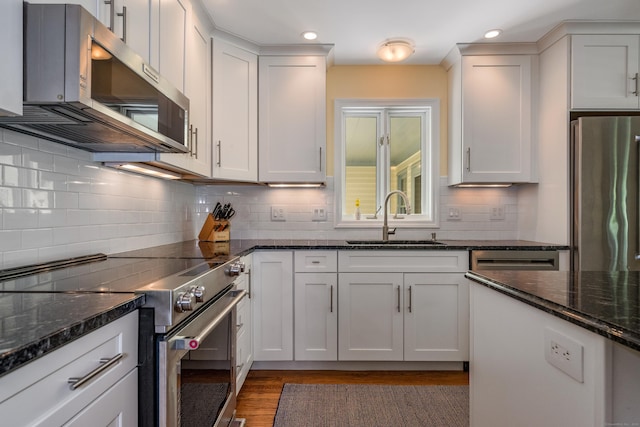 10 Oak Dr, Essex, CT 06409 - kitchen with stainless steel appliances, wood finished floors, decorative backsplash, white cabinets, and recessed lighting