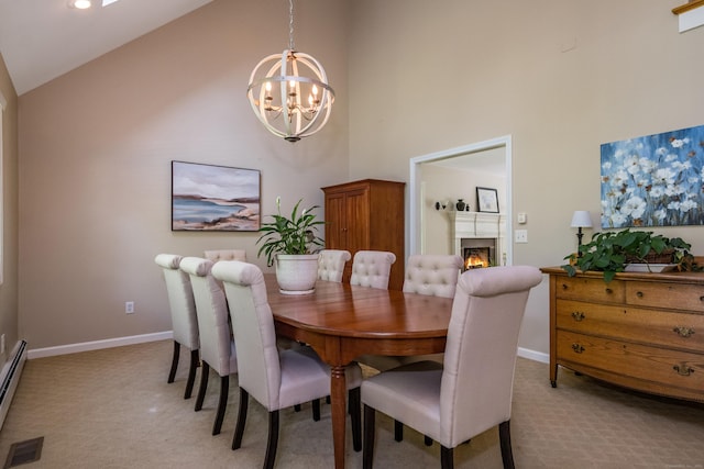 10 Oak Dr, Essex, CT 06409 - dining space with light carpet, a chandelier, high vaulted ceiling, a warm lit fireplace, and a baseboard heating unit