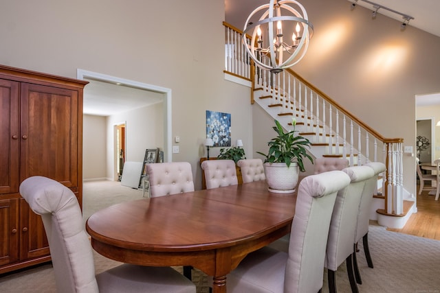 10 Oak Dr, Essex, CT 06409 - dining room with a high ceiling, a chandelier, stairs, track lighting, and light wood finished floors