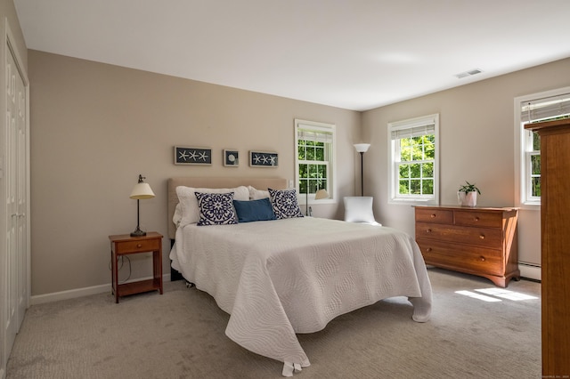 10 Oak Dr, Essex, CT 06409 - bedroom with light carpet, a baseboard radiator, and a closet