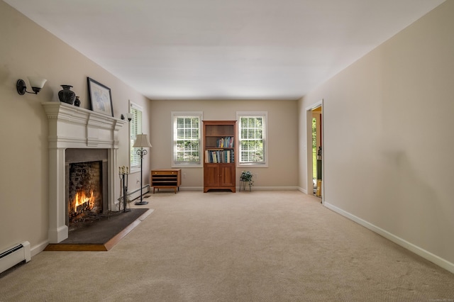 10 Oak Dr, Essex, CT 06409 - unfurnished living room featuring a baseboard radiator, a lit fireplace, and light colored carpet