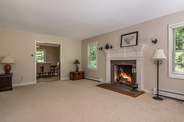 10 Oak Dr, Essex, CT 06409 - living area with a baseboard heating unit, carpet flooring, and a warm lit fireplace