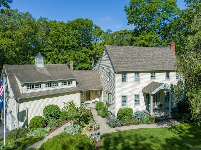 10 Oak Dr, Essex, CT 06409 - colonial inspired home with a chimney, roof with shingles, and a front lawn