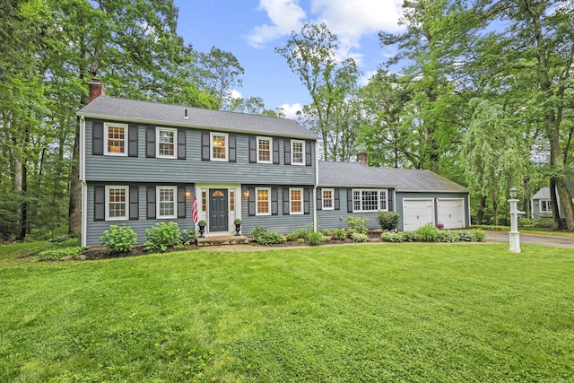 30 Clifdon Dr, Simsbury, CT 06070 - colonial house featuring a chimney, an attached garage, driveway, and a front lawn