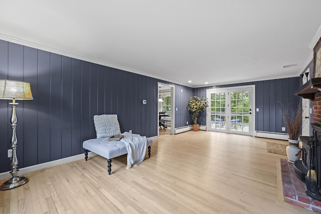 30 Clifdon Dr, Simsbury, CT 06070 - living area with ornamental molding, light wood-style flooring, a wood stove, and a baseboard radiator