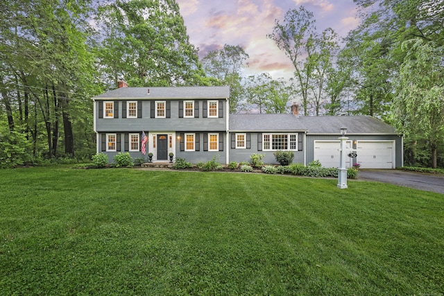 30 Clifdon Dr, Simsbury, CT 06070 - view of front of home featuring a chimney, asphalt driveway, an attached garage, and a lawn