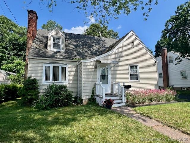 489 Adams St, Manchester, CT 06040 - view of front facade with a front yard and a chimney