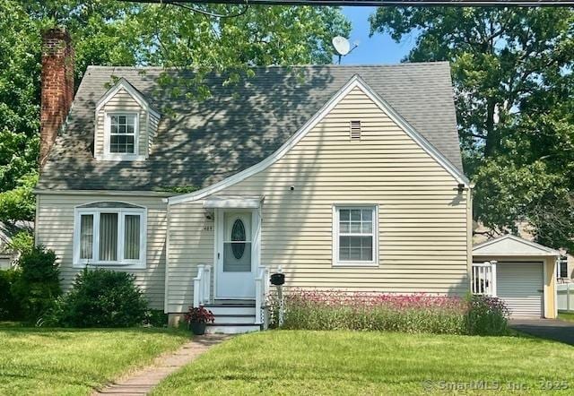 489 Adams St, Manchester, CT 06040 - cape cod house with a chimney, an outdoor structure, a front yard, and a detached garage