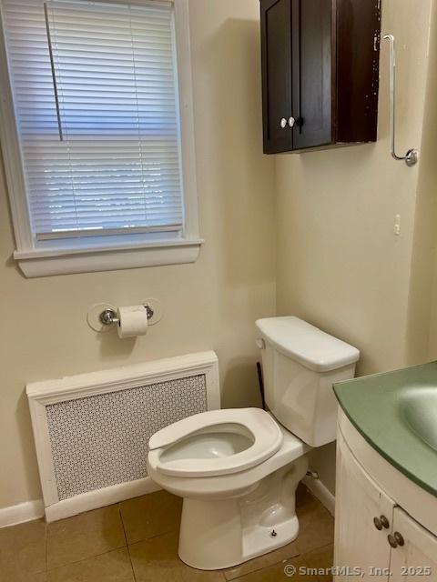 489 Adams St, Manchester, CT 06040 - bathroom with radiator heating unit, tile patterned flooring, and vanity