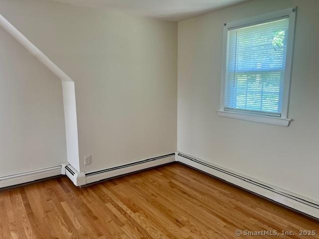 489 Adams St, Manchester, CT 06040 - unfurnished room with a baseboard heating unit and light wood-style floors