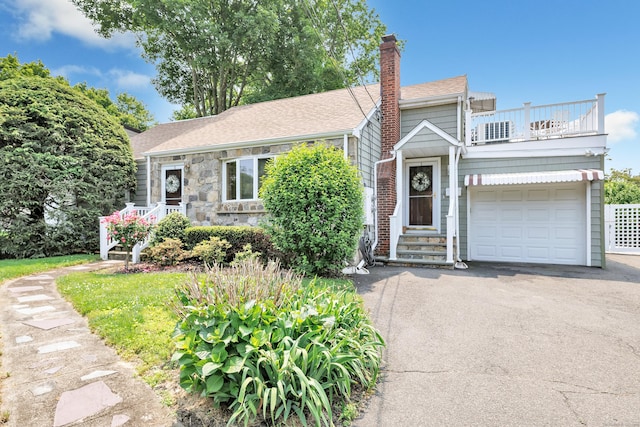 16 Senga Rd, Norwalk, CT 06854 - view of front of home featuring a balcony, asphalt driveway, a chimney, an attached garage, and a shingled roof