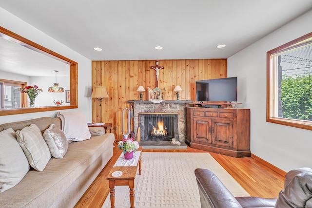 16 Senga Rd, Norwalk, CT 06854 - living room with wood finished floors, a premium fireplace, plenty of natural light, recessed lighting, and wooden walls