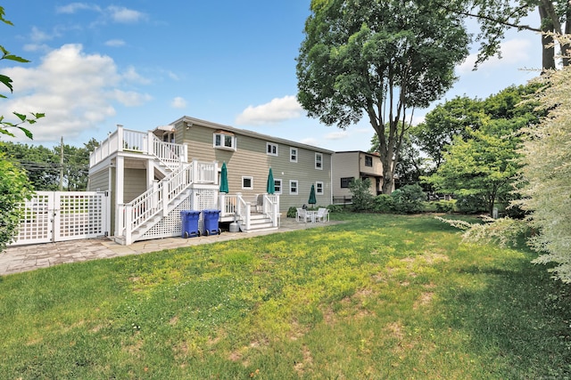 16 Senga Rd, Norwalk, CT 06854 - back of property featuring stairway, a yard, a patio, and a wooden deck