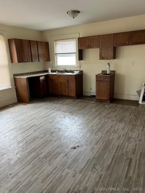 358 Orchard St, New Haven, CT 06511 - kitchen featuring wood finished floors and brown cabinets