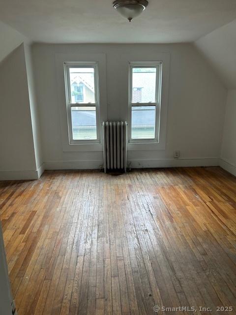 358 Orchard St, New Haven, CT 06511 - bonus room featuring radiator, hardwood / wood-style floors, and vaulted ceiling