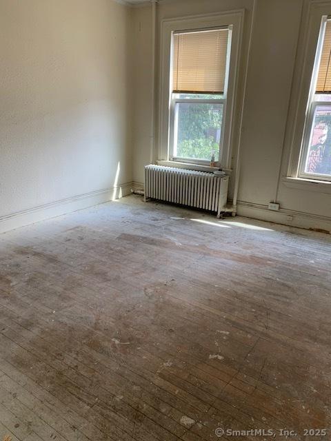358 Orchard St, New Haven, CT 06511 - unfurnished room featuring radiator heating unit, plenty of natural light, and hardwood / wood-style flooring
