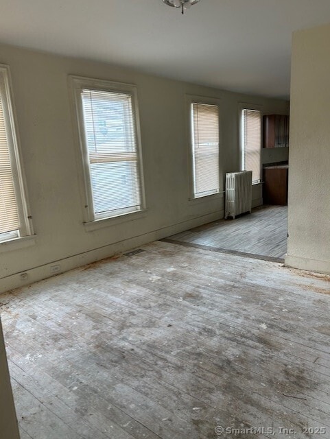 358 Orchard St, New Haven, CT 06511 - unfurnished living room featuring radiator heating unit and wood finished floors