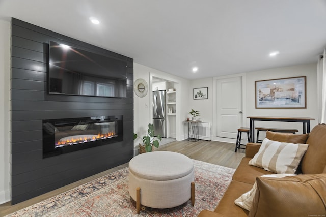 18 King St, Old Saybrook, CT 06475 - living room featuring a large fireplace, wood finished floors, recessed lighting, and built in features