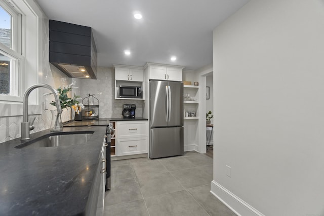 18 King St, Old Saybrook, CT 06475 - kitchen featuring freestanding refrigerator, premium range hood, tasteful backsplash, white cabinetry, and recessed lighting