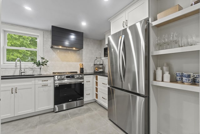 18 King St, Old Saybrook, CT 06475 - kitchen featuring appliances with stainless steel finishes, exhaust hood, dark countertops, decorative backsplash, and light tile patterned flooring