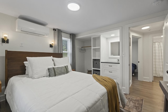 18 King St, Old Saybrook, CT 06475 - bedroom featuring a wall mounted air conditioner, light wood-style floors, and a closet