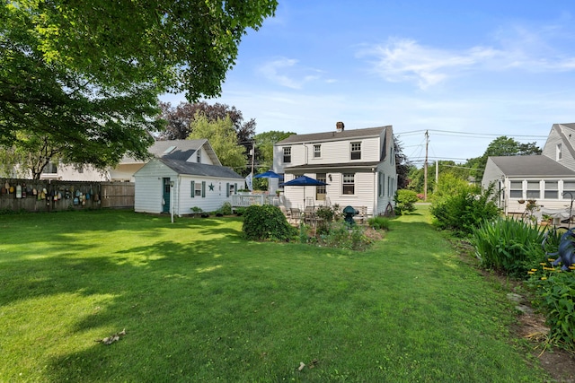 16 Lynde St, Old Saybrook, CT 06475 - rear view of property featuring an outbuilding and a chimney
