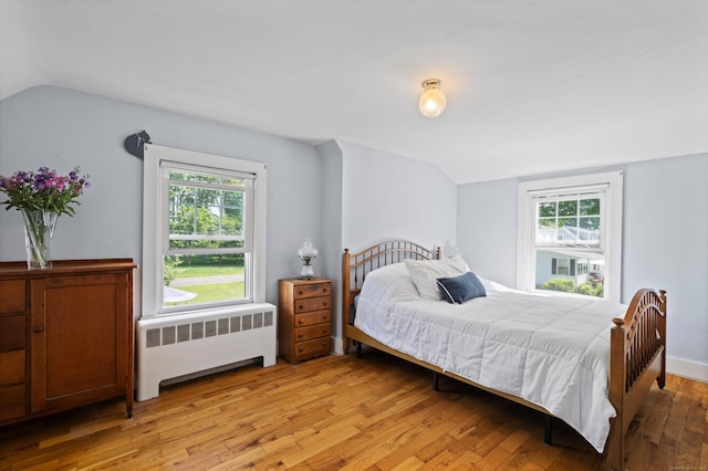 16 Lynde St, Old Saybrook, CT 06475 - bedroom with radiator, lofted ceiling, light wood-style flooring, and multiple windows