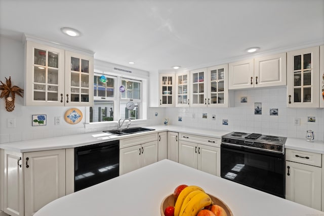 16 Lynde St, Old Saybrook, CT 06475 - kitchen featuring electric range, black dishwasher, white cabinetry, glass insert cabinets, and light countertops