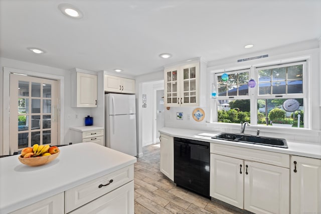 16 Lynde St, Old Saybrook, CT 06475 - kitchen featuring black dishwasher, freestanding refrigerator, light wood-type flooring, white cabinets, and recessed lighting