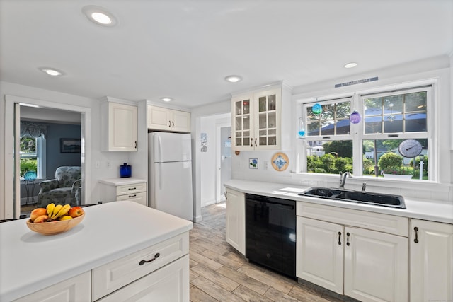 16 Lynde St, Old Saybrook, CT 06475 - kitchen with dishwasher, freestanding refrigerator, light wood-style flooring, white cabinetry, and recessed lighting