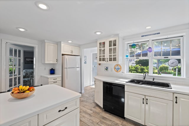 16 Lynde St, Old Saybrook, CT 06475 - kitchen with freestanding refrigerator, dishwasher, plenty of natural light, white cabinetry, and recessed lighting