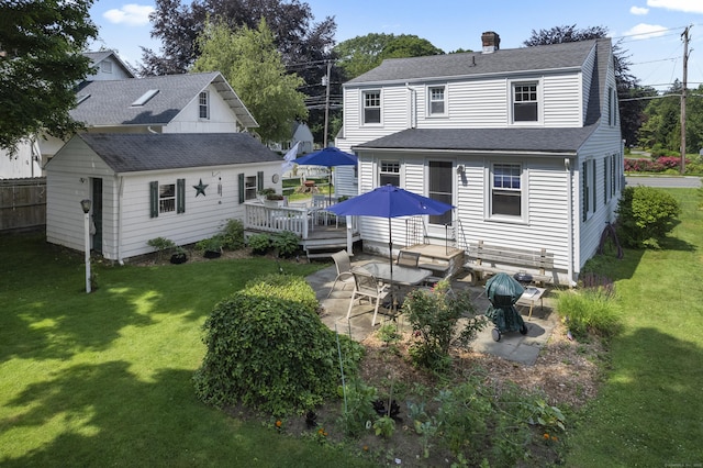 16 Lynde St, Old Saybrook, CT 06475 - back of property with a wooden deck, a patio, a yard, and a shingled roof