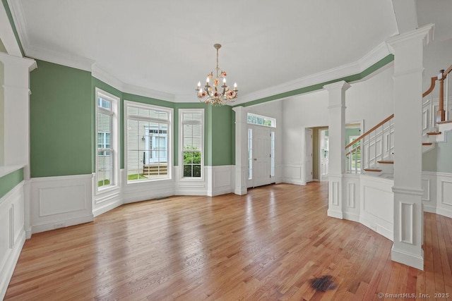 9 Meadowview Ct Unit 9, Canton, CT 06019 - unfurnished room featuring a decorative wall, stairway, light wood-style flooring, wainscoting, and crown molding