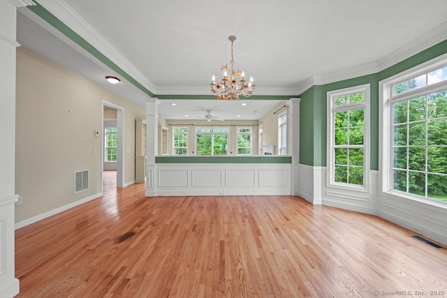 9 Meadowview Ct Unit 9, Canton, CT 06019 - unfurnished living room with ornate columns, a chandelier, light wood-type flooring, crown molding, and plenty of natural light