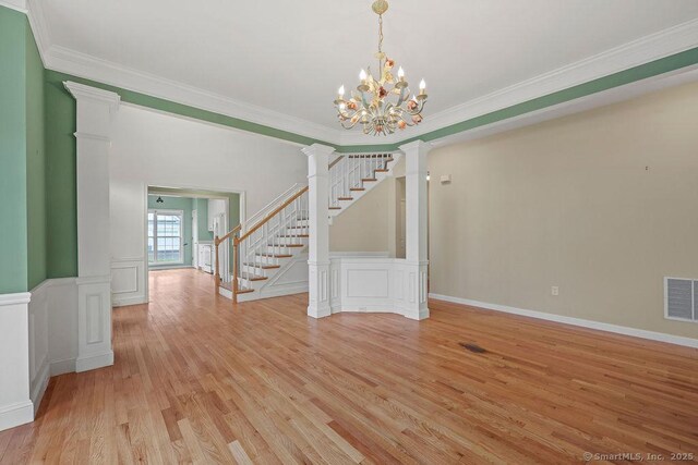 9 Meadowview Ct Unit 9, Canton, CT 06019 - spare room with light wood-style floors, crown molding, stairway, a chandelier, and decorative columns