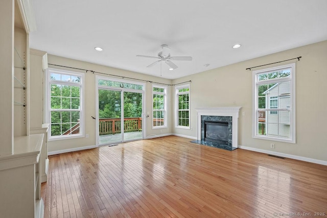 9 Meadowview Ct Unit 9, Canton, CT 06019 - unfurnished living room with healthy amount of natural light, a ceiling fan, light wood-style floors, a high end fireplace, and recessed lighting