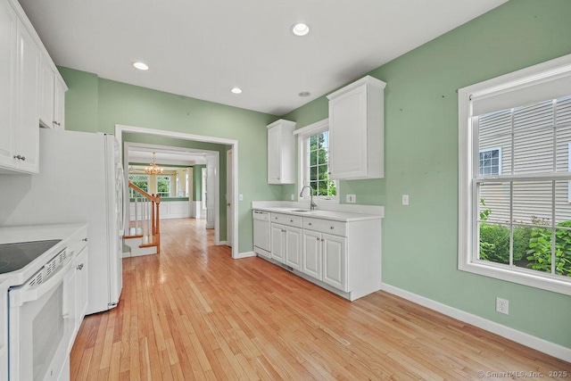 9 Meadowview Ct Unit 9, Canton, CT 06019 - kitchen with white appliances, light countertops, white cabinets, light wood-style flooring, and a chandelier