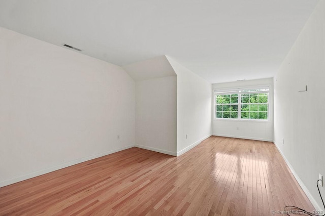9 Meadowview Ct Unit 9, Canton, CT 06019 - unfurnished room with light wood-style floors and lofted ceiling