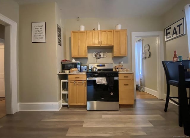 84 Love Ln, Hartford, CT 06112 - kitchen featuring stainless steel range with electric stovetop, light brown cabinets, wood finished floors, and light countertops