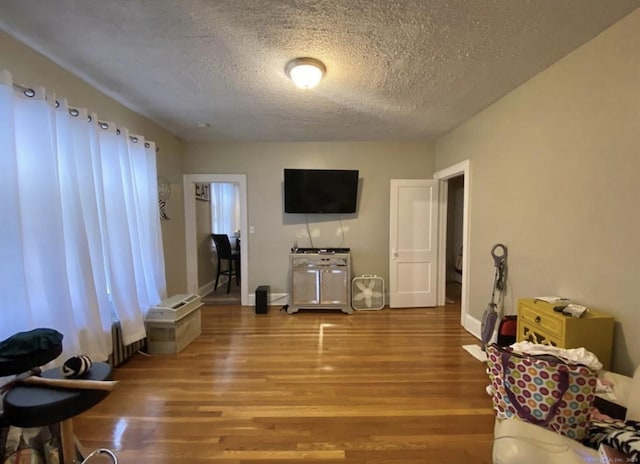 84 Love Ln, Hartford, CT 06112 - living area featuring a textured ceiling and wood finished floors