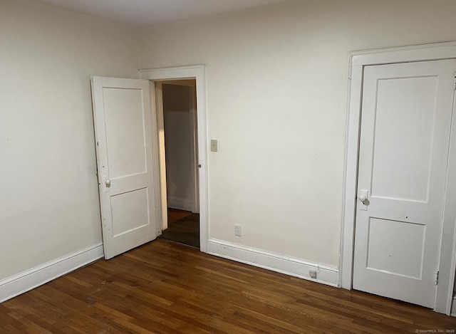 84 Love Ln, Hartford, CT 06112 - unfurnished bedroom with baseboards and dark wood-type flooring