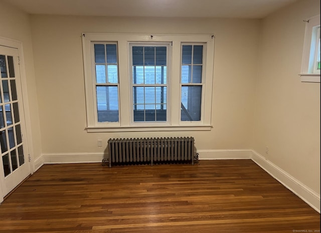 84 Love Ln, Hartford, CT 06112 - unfurnished room featuring radiator heating unit and dark wood-style floors