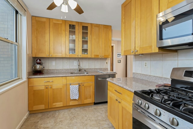 50 Glenbrook Rd Apt 7C, Stamford, CT 06902 - kitchen with stainless steel appliances, tasteful backsplash, a ceiling fan, and glass insert cabinets