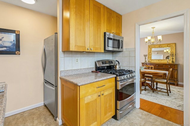 50 Glenbrook Rd Apt 7C, Stamford, CT 06902 - kitchen with stainless steel appliances, a chandelier, and tasteful backsplash