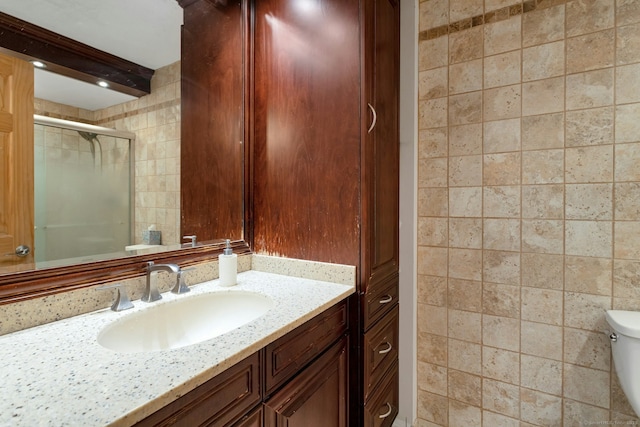 50 Glenbrook Rd Apt 7C, Stamford, CT 06902 - bathroom with tile walls, vanity, and a stall shower