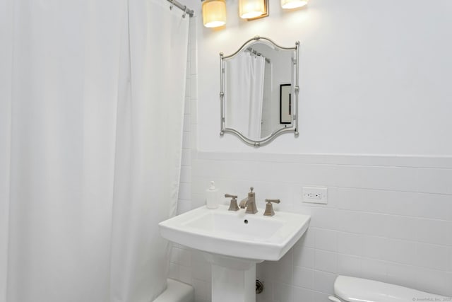 50 Glenbrook Rd Apt 7C, Stamford, CT 06902 - full bathroom featuring tile walls, a wainscoted wall, and shower / bath combination with curtain