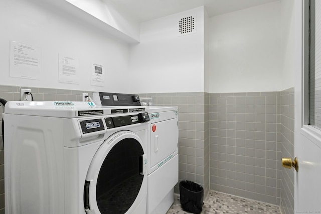50 Glenbrook Rd Apt 7C, Stamford, CT 06902 - shared laundry room featuring washer and dryer, tile walls, and a wainscoted wall