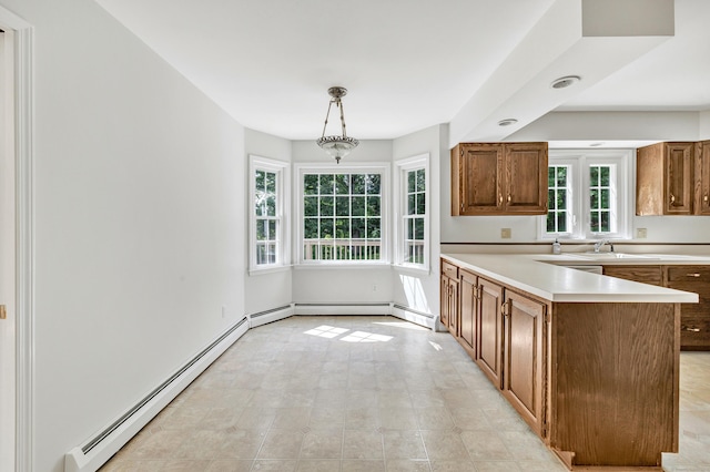 90 Chamberlain Dr, Shelton, CT 06484 - kitchen with light countertops, baseboard heating, brown cabinets, a peninsula, and hanging light fixtures