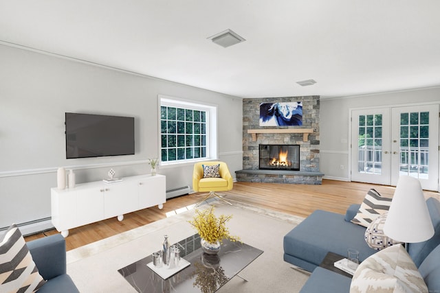 90 Chamberlain Dr, Shelton, CT 06484 - living room featuring a baseboard heating unit, wood finished floors, and a stone fireplace