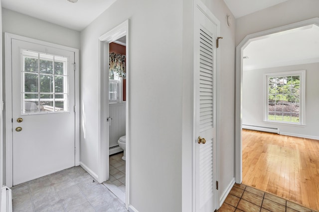 90 Chamberlain Dr, Shelton, CT 06484 - hallway featuring baseboard heating, a baseboard radiator, and light tile patterned flooring